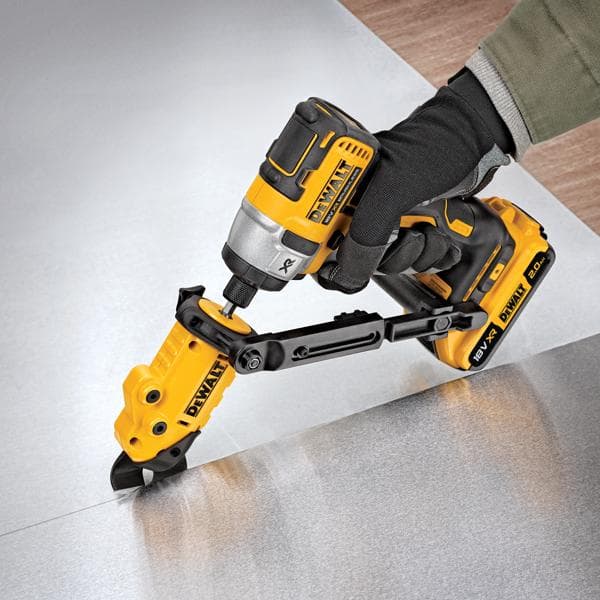DEWALT gereedschap met hulpstuk snijdt plaatmetaal, bediend door een hand met handschoen.